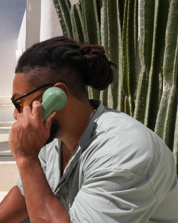Corey on the phone at the villa